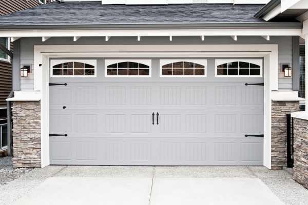 Modern steel craft garage doors enhance curb appeal in Edmonton residential area Modern steel craft garage doors enhance curb appeal in Edmonton residential area